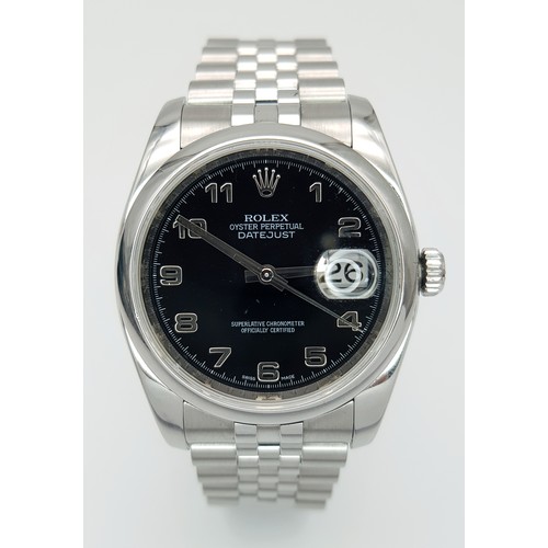 A Rolex Oyster Perpetual Datejust Gents Watch. Stainless steel bracelet and case - 36mm. Black dial with Arabic markers. In good condition and working order. TTB064. Comes with a pouch.