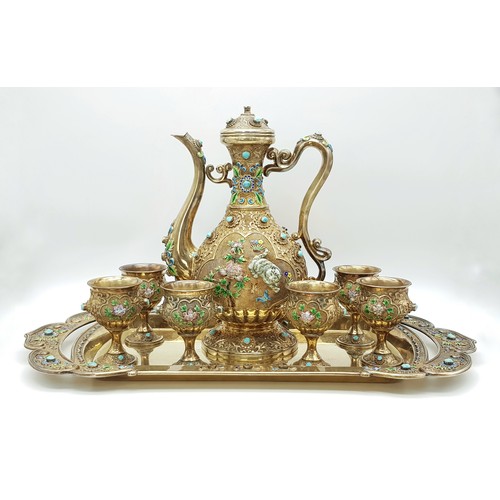 A Magnificent Chinese 20th Century, Solid Silver and Enamel Tea Set and Tray. Incredible workmanship. A superb handmade full size teapot or wine pot ewer with six original matching goblet cups and matching original serving tray. The set is constructed of thick solid sterling silver, that is then richly gold gilded throughout. Enamel and filigree work with turquoise jewelling. Each part is hallmarked Chinese silver (stamped SILVER).  Good condition but with minor imperfections including some missing stones consistent with the fragile nature and vintage age. Overall, substantially fine and intact as seen. UV light reveals no hidden damage, touch ups or repairs. Several of the pieces could use a minor cleaning. Teapot/wine ewer measures approx 11 inches tall, 7.5 inches in length and holds 1250ml or 42oz. Each cups measure approx 3 and 5/8 inches tall, 2.25 inches diameter at the rim. Serving platter tray measures approx 20 inches in length across the handles, 10 inches wide overall, or the serving area measures 13 and 3/4 inches x 7 inches. 3427g total weight for the set. We are told the collector paid upwards of $20,000 for this set 25 -30 years ago and that such sets are highly sought after by prominent families and collectors. Winning bidder must collect from Cadmore HQ or arrange a courier.