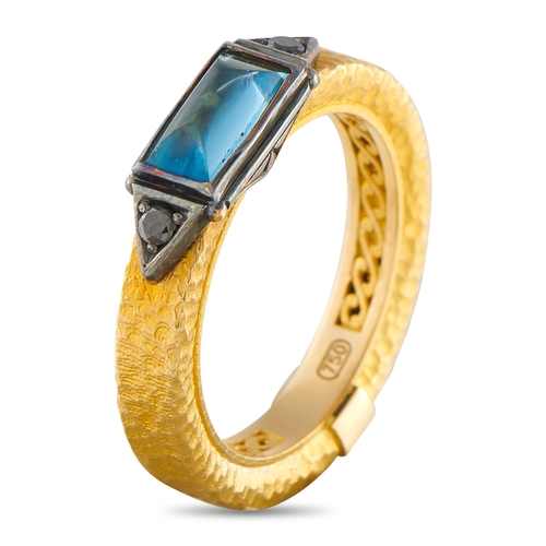 19 - A Konstantino 18K Yellow Gold Black Diamond and Topaz Ring. A blue Topaz gemstone in an east-west ar... 