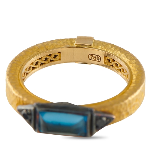 19 - A Konstantino 18K Yellow Gold Black Diamond and Topaz Ring. A blue Topaz gemstone in an east-west ar... 