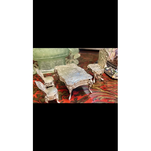 36 - A SET OF EARLY 20TH CENTURY SILVER MINIATURE FURNITURE, C.1900the miniature set comprising a dining ... 