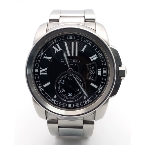 A Cartier Calibre de Cartier Automatic Gents Watch. Model W7100016. Stainless steel bracelet and case - 42mm. Black dial with Roman numerals and sub dial. Date window. Skeleton back. Comes with spare strap, link, pouch and an array of papers. In working order. Ref: 028240.