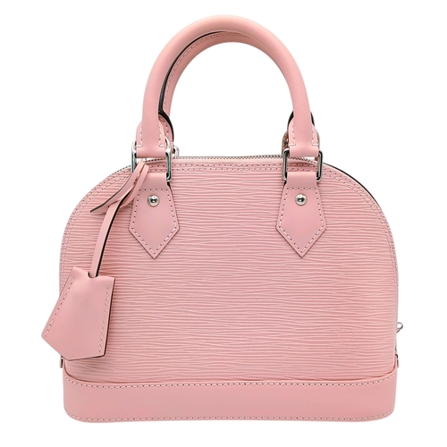 A Pale Pink Louis Vuitton Ballerine Epi Leather Alma BB Handbag. Pale pink textured Epi leather exterior with silver-toned hardware, dual rolled top handles, protective base studs and zipped top closure. Pink textile interior with one main compartment and an open side pocket. Approx 28cm length x 17cm height x 11cm depth. Comes with a certificate of authenticity, clochette, padlock, keys, detachable should strap, dust cover and box. Some marks and stains to the leather but in fair condition overall. Please see photos or request a condition report. Ref: 28638.