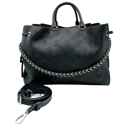 A Louis Vuitton Black Mahina Leather Bella Tote Bag. Black perforated Mahina leather exterior with silver-toned hardware, dual rolled top handles, leather-threaded chain shoulder strap, protected base studs and drawstring side closures. Brown leather interior with two main compartments and a central zipped pocket. Approx 37cm length x 22cm height x 14cm depth. Comes with a detachable shoulder strap. Some marks and signs of wear to the leather. Please see photos or request a condition report. Ref: 28613.