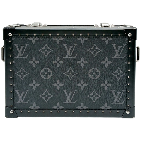 A Black Louis Vuitton Monogram Eclipse Petite Malle Shoulder Bag. Black monogram Eclipse coated canvas exterior with silver-toned hardware, top clasp closures and detachable adjustable leather shoulder strap. Black leather interior with two main compartments and a central zipped pocket. Approx 22cm length x 15cm height x 7cm depth. Some scratches, stains and signs of wear to the leather. Comes with a certificate of authenticity. Please see photos or request a condition report. Ref: 28609.