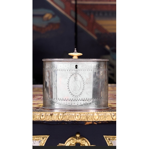 AN 18TH CENTURY STERLING SILVER TEA CADDY WITH KEY, C. 1785 THOMAS CHAWNERthe George III period Neo-classical style tea caddy of oval form with bone handle, the body decorated with a heraldic crest to the front, hallmarked to underside, London, 1785, maker's mark for Thomas Chawner, 500 grams overall,16cm wide x 12.5cm high
