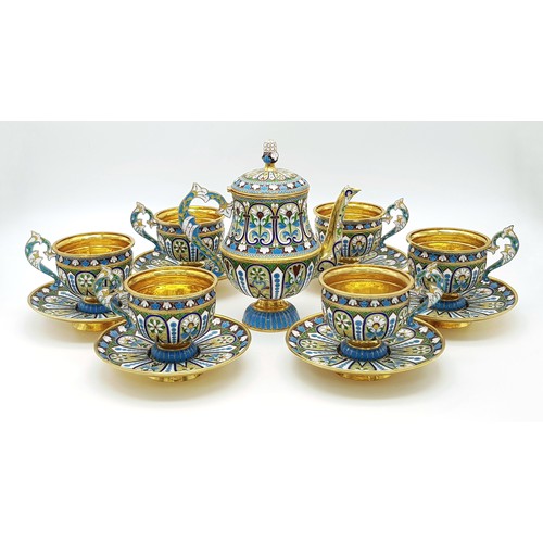 A Large Russian Style Enamelled Silver Gilt Tea Set. Comprising: one tea pot (approx 18cm height), six tea cups (approx 8cm height) and matching saucers. Total weight: 2.36kg. Winning bidder must collect from Cadmore HQ or arrange a courier.