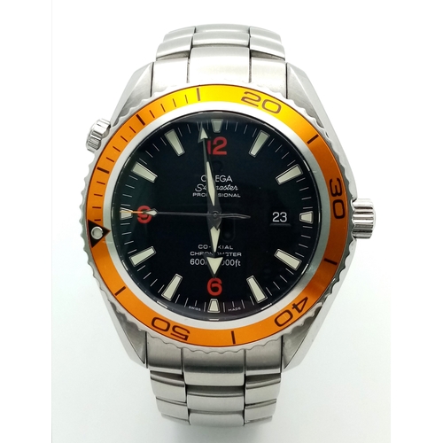 An Omega Seamaster Planet Ocean (c.2007) Automatic Gents Divers Watch. Calibre 2500. Stainless steel bracelet and case - 45mm. 51mm lug to lug. Black dial with date window. Orange rotating bezel. In working order. Comes with an Omega case and a Watch register report.