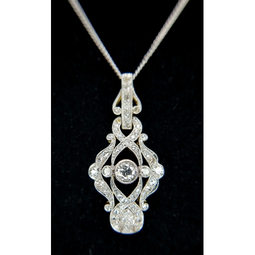 A Gold and Platinum Art Deco Pendant on an 18K Gold Chain. c1.2ctw of old cut diamonds (one stone missing). 3cm pendant. 42cm chain. 5.6g total weight. Ref: 1.7.