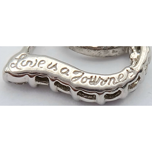 559 - A 9K WHITE GOLD, DIAMOND SET, OPEN HEART PENDANT. ENGRAVED ON THE BACK 