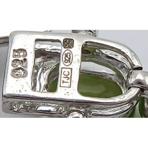 515 - An Elegant Sterling Silver Peridot Set Tennis Bracelet-20cm Length. Set with Thirty-Two 5 x 4mm Oval... 