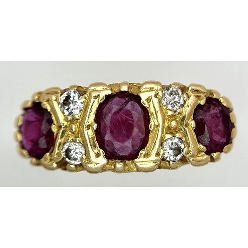 11 - AN 18K GOLD 3 STONE GYPSY STYLE RING WITH LARGE RUBY STONES SEPERATED BY 4 DIAMONDS .     5.8gms    ... 