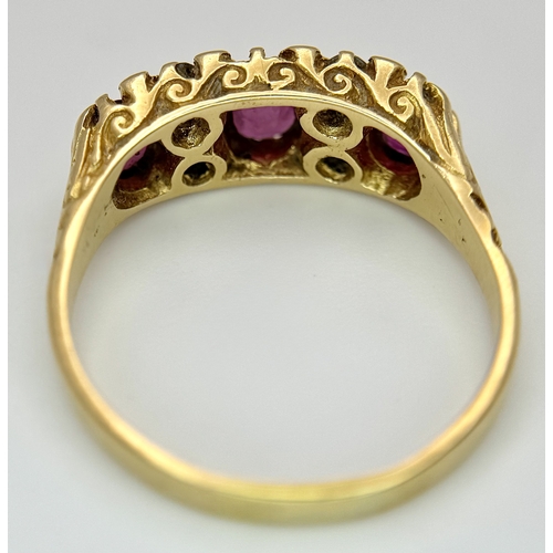 11 - AN 18K GOLD 3 STONE GYPSY STYLE RING WITH LARGE RUBY STONES SEPERATED BY 4 DIAMONDS .     5.8gms    ... 