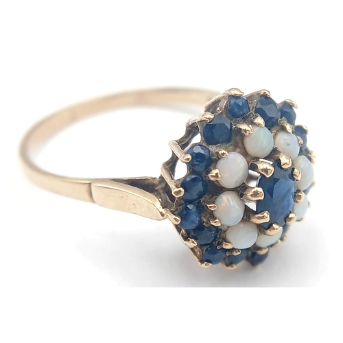 36 - A 9K GOLD RING WITH A CLUSTER OF OPAL AND SAPPHIRES.    2.9fms    size T