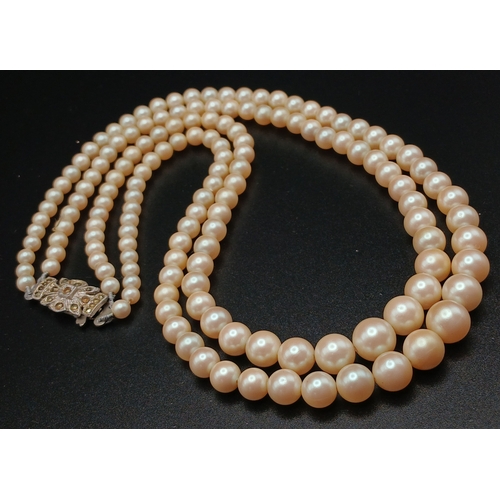 555 - A VINTAGE(1950'S) SET OF SIMULATED PEARLS IN A GRADUATED TWIN CHOKER STYLE AND IN THE ORIGINAL BOX .