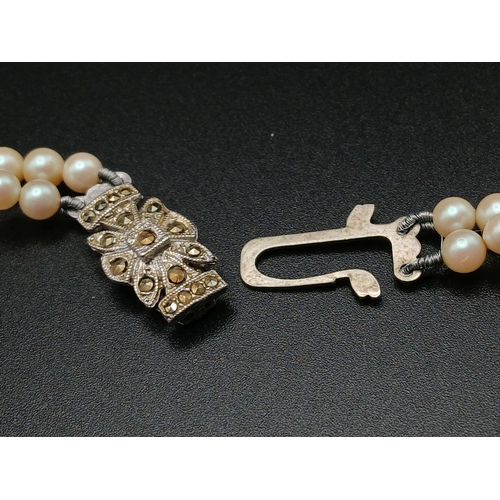 555 - A VINTAGE(1950'S) SET OF SIMULATED PEARLS IN A GRADUATED TWIN CHOKER STYLE AND IN THE ORIGINAL BOX .