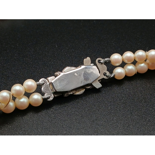 555 - A VINTAGE(1950'S) SET OF SIMULATED PEARLS IN A GRADUATED TWIN CHOKER STYLE AND IN THE ORIGINAL BOX .