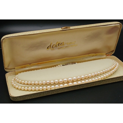 555 - A VINTAGE(1950'S) SET OF SIMULATED PEARLS IN A GRADUATED TWIN CHOKER STYLE AND IN THE ORIGINAL BOX .