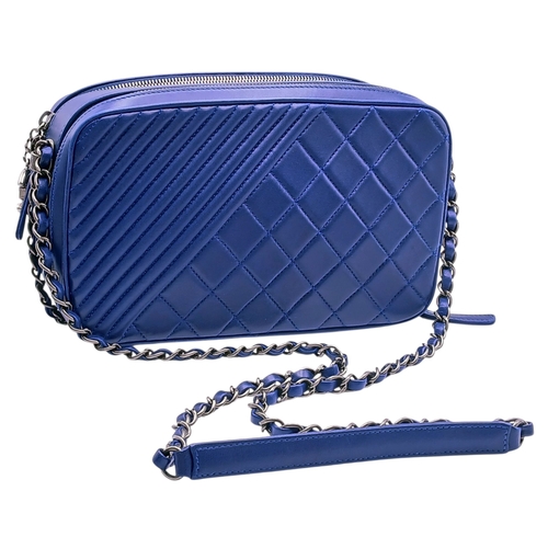 33 - A Chanel Blue Quilted Leather Camera Bag. Blue leather exterior with silver-toned hardware, chain an... 