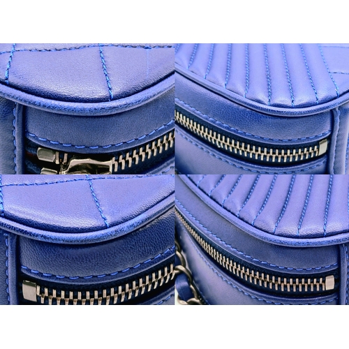 33 - A Chanel Blue Quilted Leather Camera Bag. Blue leather exterior with silver-toned hardware, chain an... 