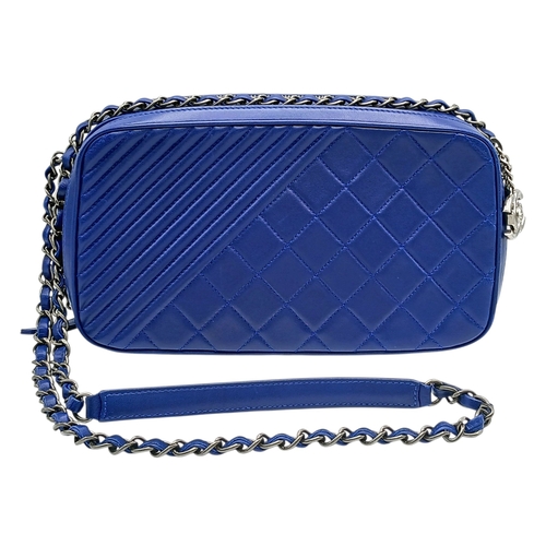 33 - A Chanel Blue Quilted Leather Camera Bag. Blue leather exterior with silver-toned hardware, chain an... 
