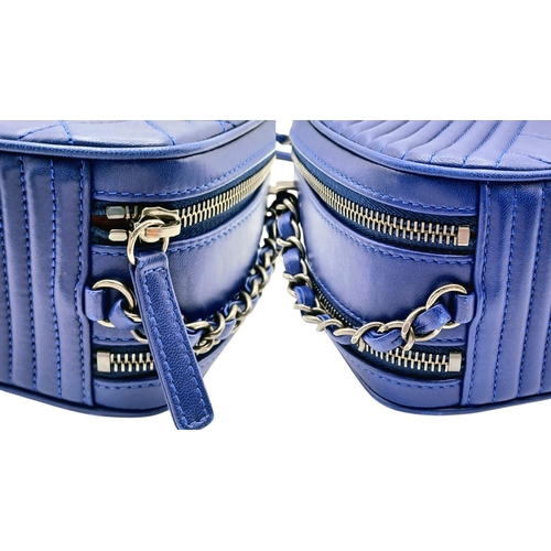 33 - A Chanel Blue Quilted Leather Camera Bag. Blue leather exterior with silver-toned hardware, chain an... 