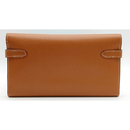 19 - An Hermès Tan Epsom Leather Kelly Long Wallet. Tan Epsom leather exterior with silver-toned hardware... 
