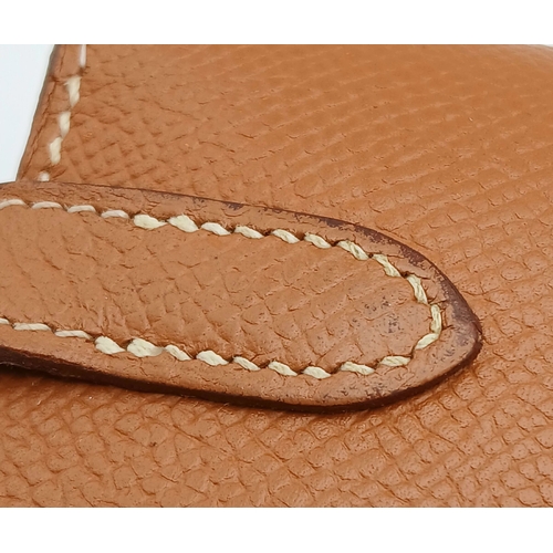 19 - An Hermès Tan Epsom Leather Kelly Long Wallet. Tan Epsom leather exterior with silver-toned hardware... 