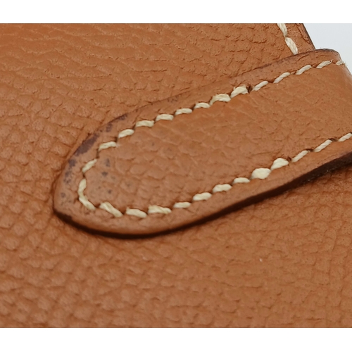 19 - An Hermès Tan Epsom Leather Kelly Long Wallet. Tan Epsom leather exterior with silver-toned hardware... 
