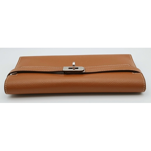 19 - An Hermès Tan Epsom Leather Kelly Long Wallet. Tan Epsom leather exterior with silver-toned hardware... 