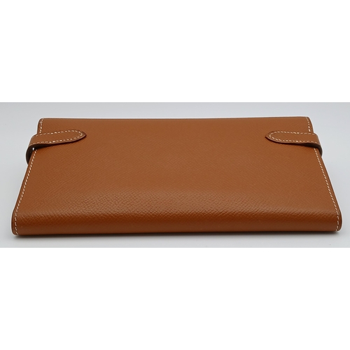 19 - An Hermès Tan Epsom Leather Kelly Long Wallet. Tan Epsom leather exterior with silver-toned hardware... 