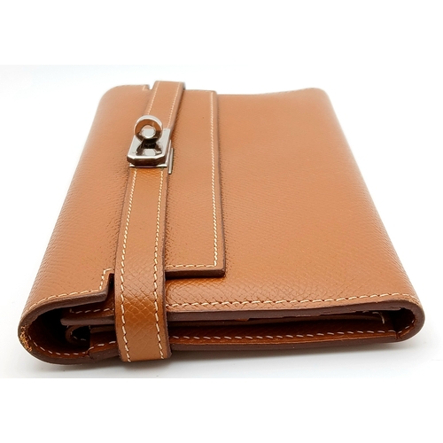 19 - An Hermès Tan Epsom Leather Kelly Long Wallet. Tan Epsom leather exterior with silver-toned hardware... 