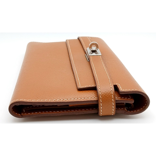 19 - An Hermès Tan Epsom Leather Kelly Long Wallet. Tan Epsom leather exterior with silver-toned hardware... 