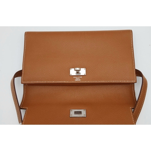 19 - An Hermès Tan Epsom Leather Kelly Long Wallet. Tan Epsom leather exterior with silver-toned hardware... 