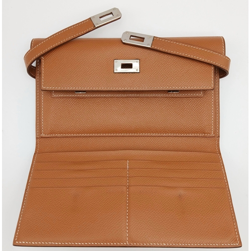 19 - An Hermès Tan Epsom Leather Kelly Long Wallet. Tan Epsom leather exterior with silver-toned hardware... 