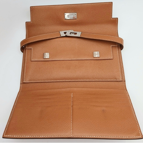 19 - An Hermès Tan Epsom Leather Kelly Long Wallet. Tan Epsom leather exterior with silver-toned hardware... 