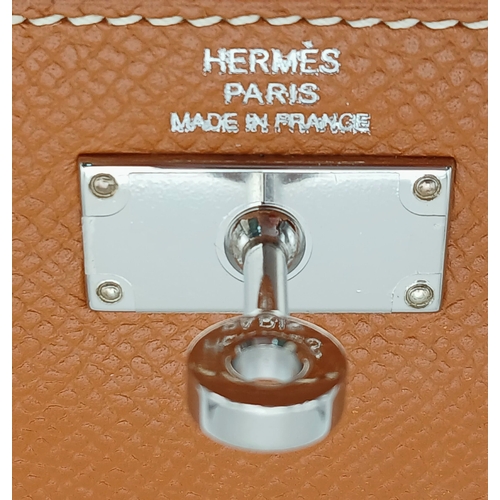 19 - An Hermès Tan Epsom Leather Kelly Long Wallet. Tan Epsom leather exterior with silver-toned hardware... 