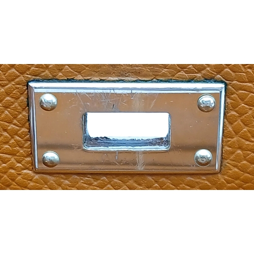19 - An Hermès Tan Epsom Leather Kelly Long Wallet. Tan Epsom leather exterior with silver-toned hardware... 