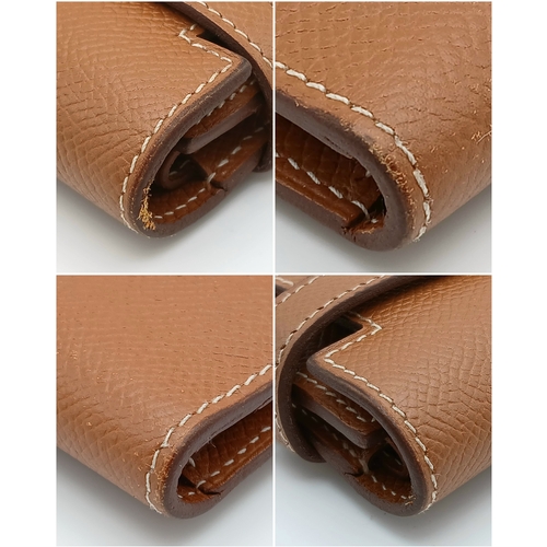 19 - An Hermès Tan Epsom Leather Kelly Long Wallet. Tan Epsom leather exterior with silver-toned hardware... 