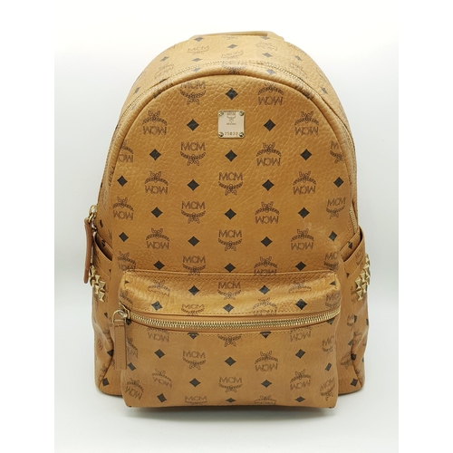 5 - An MCM Visetos Large Stark Backpack. Cognac MCM monogram coated canvas exterior with gold-toned hard... 