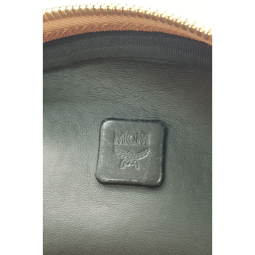 5 - An MCM Visetos Large Stark Backpack. Cognac MCM monogram coated canvas exterior with gold-toned hard... 