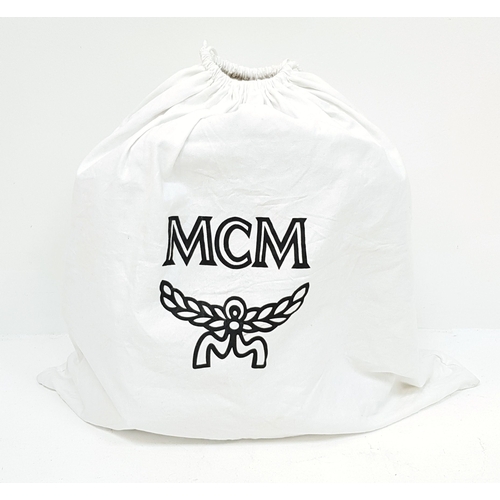 5 - An MCM Visetos Large Stark Backpack. Cognac MCM monogram coated canvas exterior with gold-toned hard... 