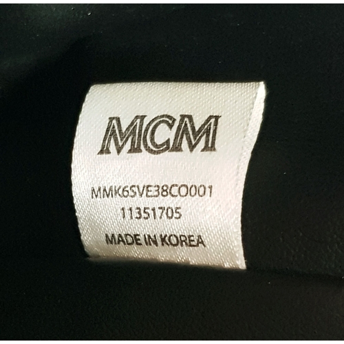 5 - An MCM Visetos Large Stark Backpack. Cognac MCM monogram coated canvas exterior with gold-toned hard... 
