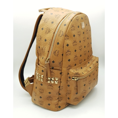 5 - An MCM Visetos Large Stark Backpack. Cognac MCM monogram coated canvas exterior with gold-toned hard... 