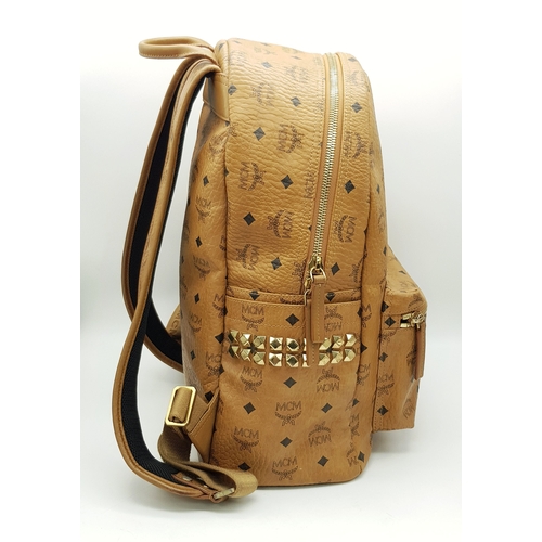 5 - An MCM Visetos Large Stark Backpack. Cognac MCM monogram coated canvas exterior with gold-toned hard... 