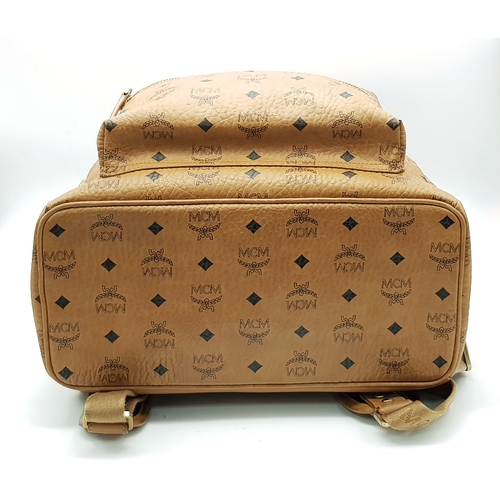 5 - An MCM Visetos Large Stark Backpack. Cognac MCM monogram coated canvas exterior with gold-toned hard... 