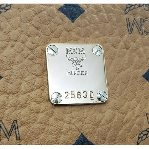 5 - An MCM Visetos Large Stark Backpack. Cognac MCM monogram coated canvas exterior with gold-toned hard... 