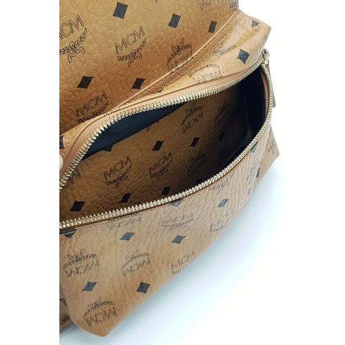 5 - An MCM Visetos Large Stark Backpack. Cognac MCM monogram coated canvas exterior with gold-toned hard... 
