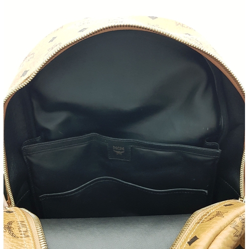 5 - An MCM Visetos Large Stark Backpack. Cognac MCM monogram coated canvas exterior with gold-toned hard... 