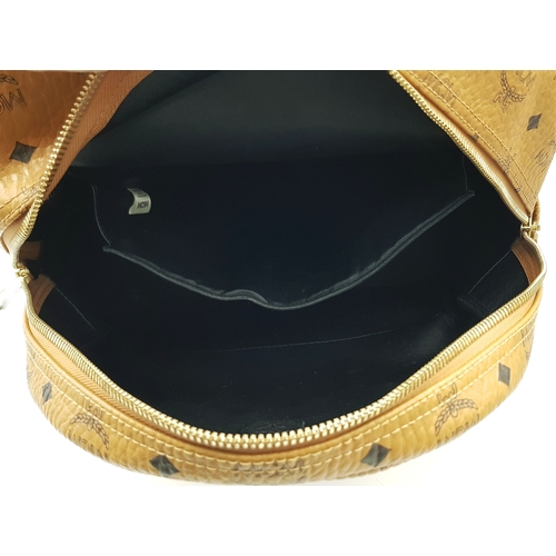 5 - An MCM Visetos Large Stark Backpack. Cognac MCM monogram coated canvas exterior with gold-toned hard... 